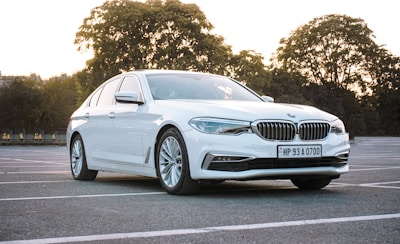 A clean, white economy sedan parked in a sunny lot.