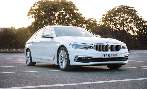 A sleek used German car parked in a sunny lot, showcasing its polished exterior.