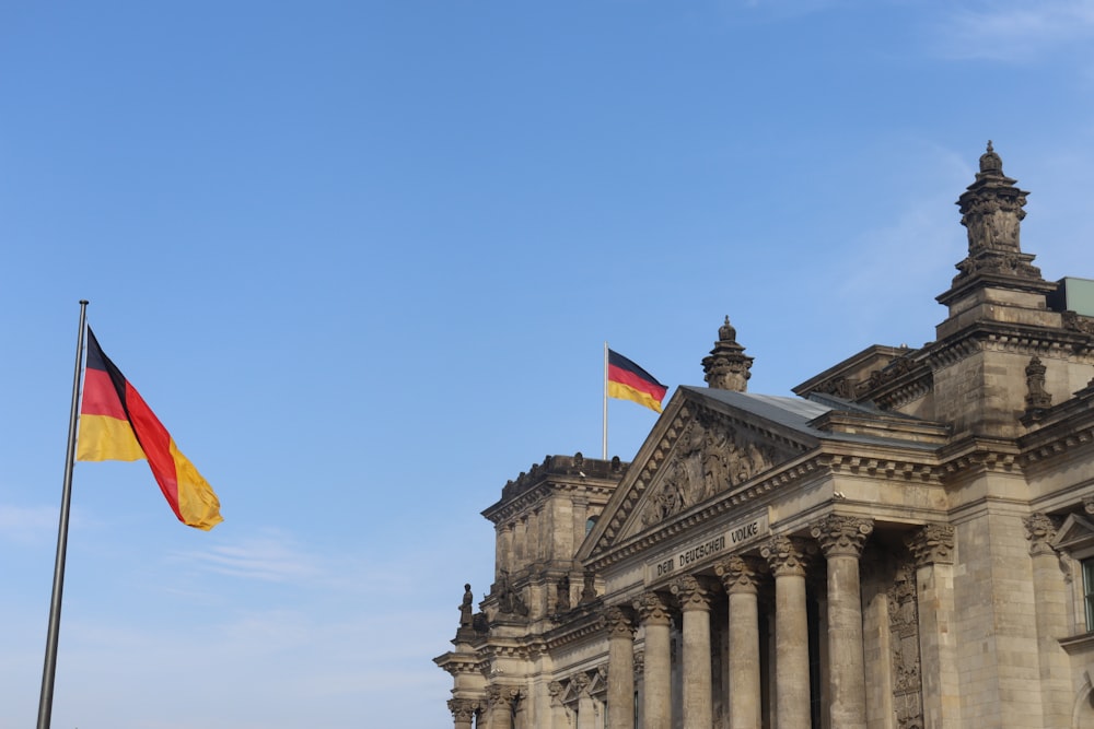 a german flag flying in front of a building