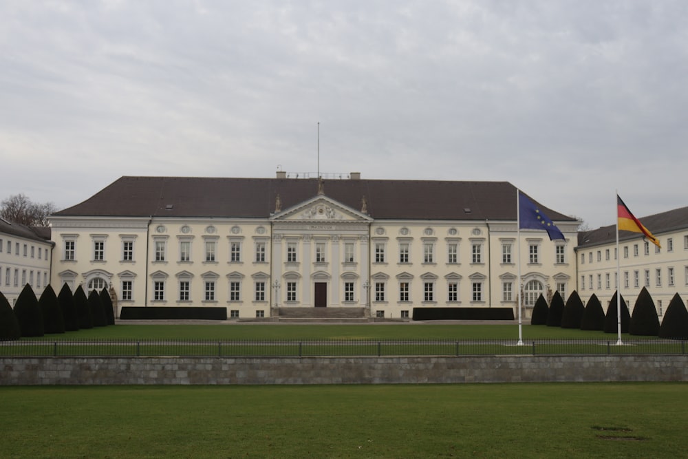 a large white building with a flag on top of it