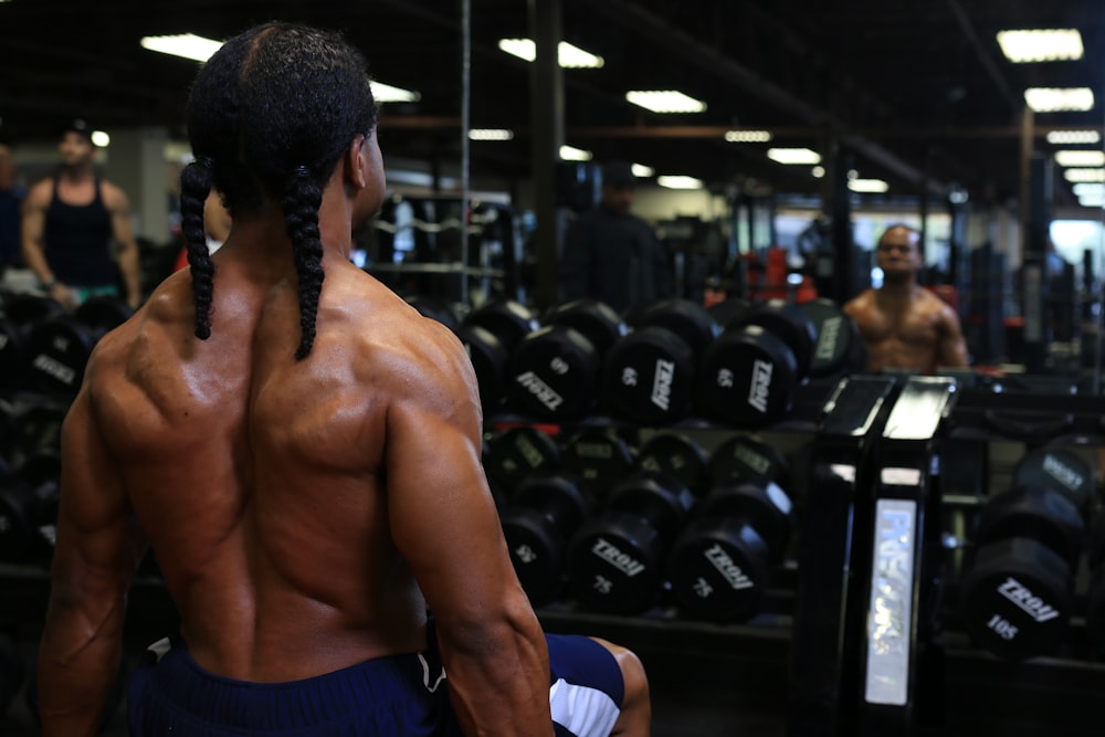 a man with no shirt in a gym