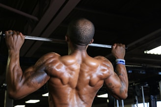 a man with a barbell in a gym