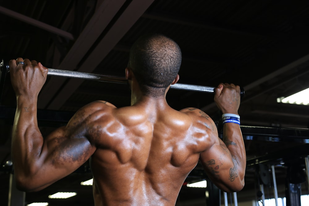 a man with a barbell in a gym