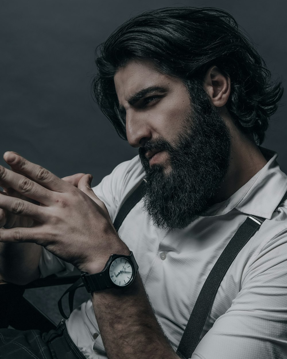 a man with a beard and a watch on his wrist