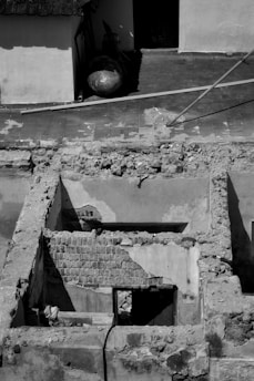 A chaotic, half-built structure with scattered tools and whimsical signs reflecting a work in progress.