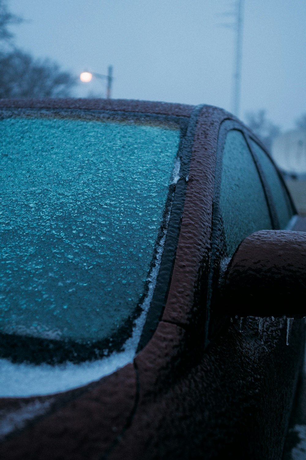 a car covered in snow on a snowy day