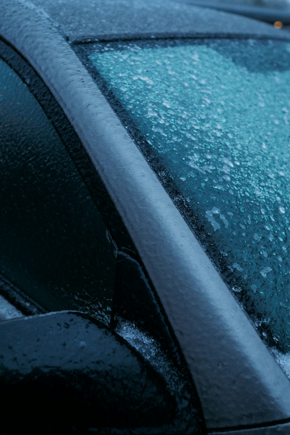 a close up of the windshield of a car covered in snow