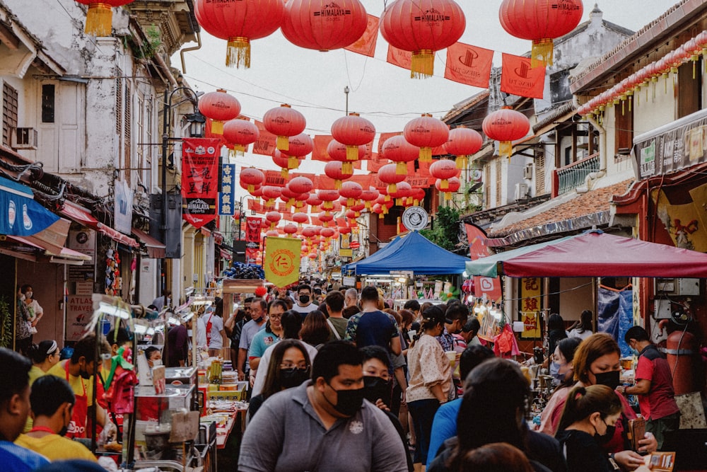 a group of people walking down a crowded street