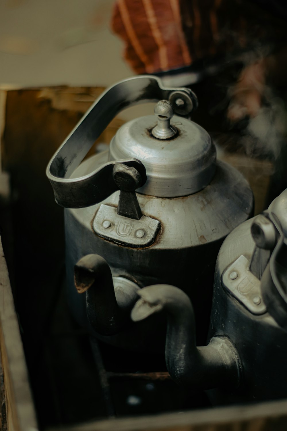a tea kettle sitting on top of a wooden box