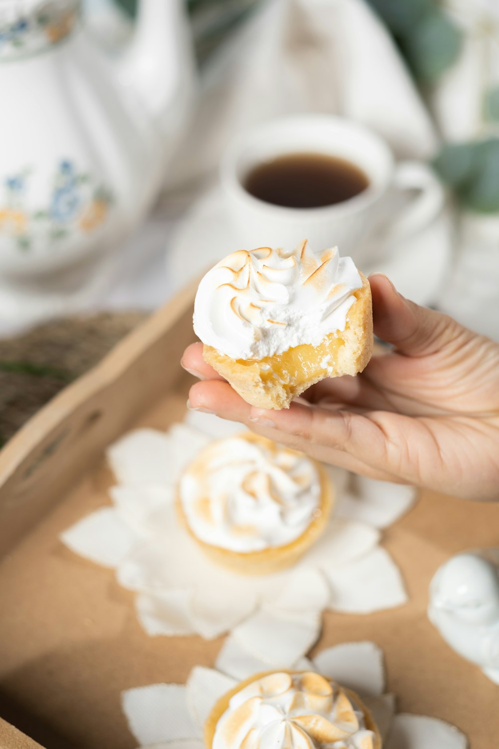 a person holding a pastry in their hand