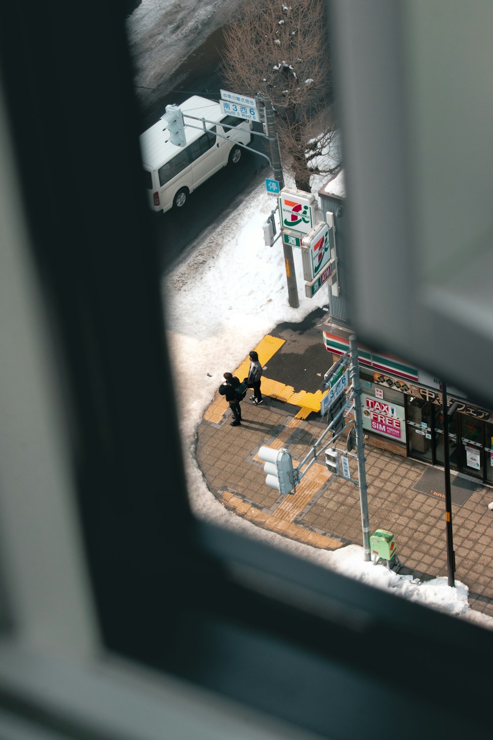 a man standing on a sidewalk in front of a gas station