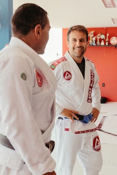 a man standing next to another man in a room