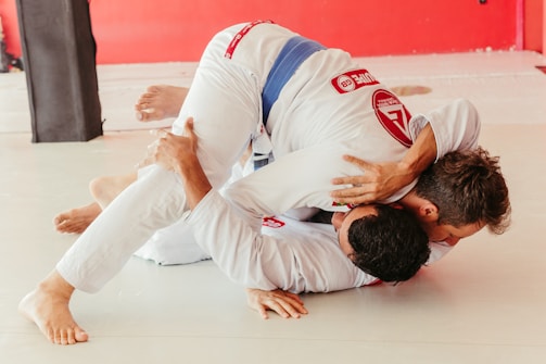 a man in a white suit is doing a trick on another man