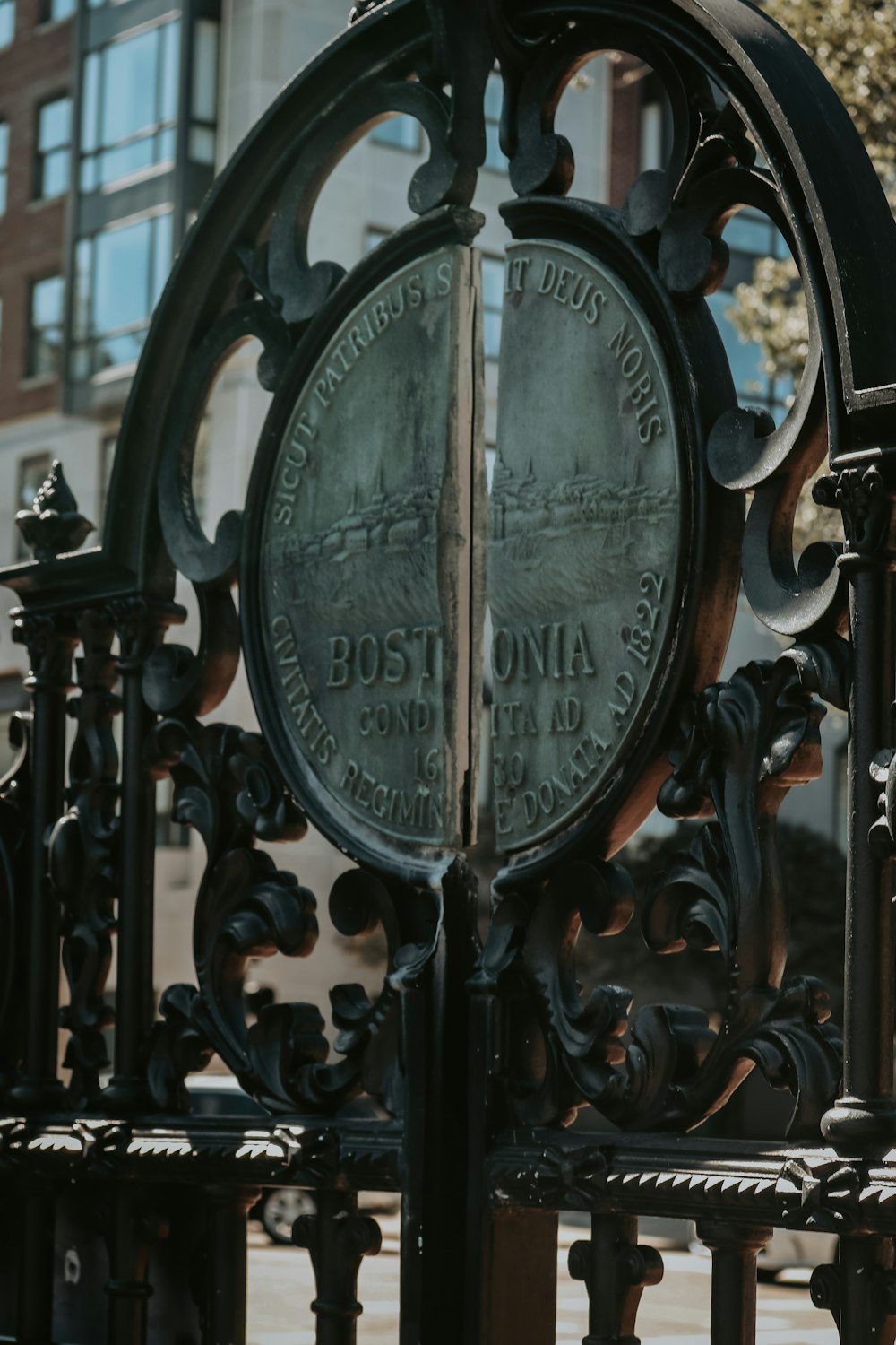 a close up of a metal fence with a clock on it