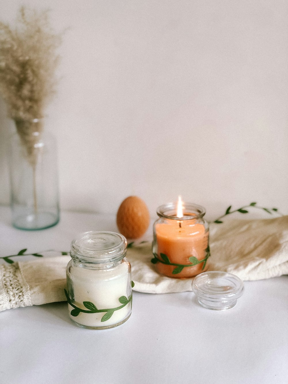 a table topped with candles and a vase filled with flowers