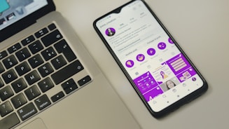 a cell phone sitting next to a laptop computer