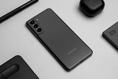 Modern smartphones and accessories laid out on a sleek black background