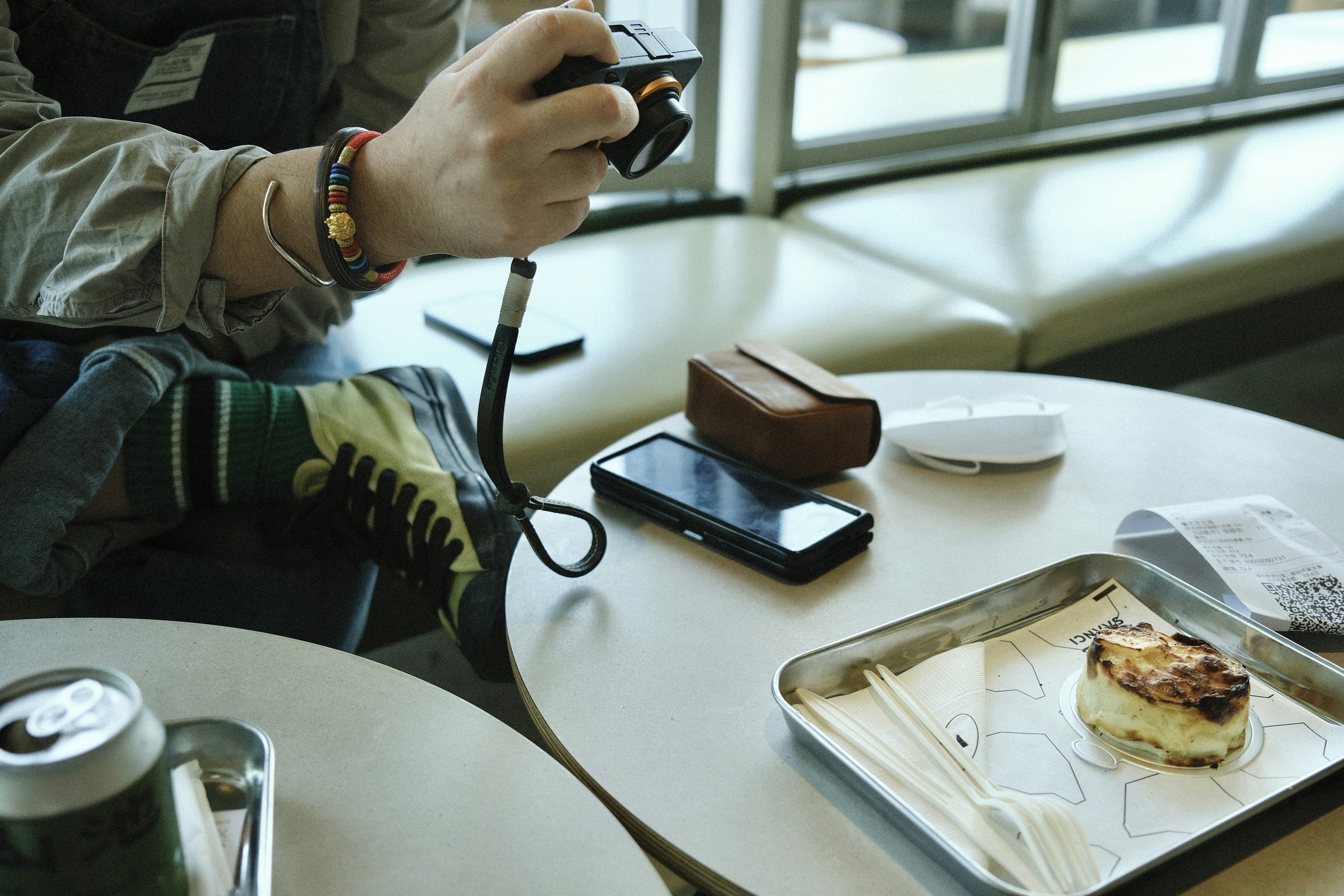 A person taking a picture of food on a table