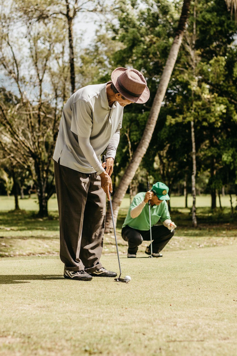 a man in a hat is playing golf