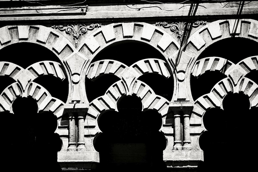 a black and white photo of a building with arches