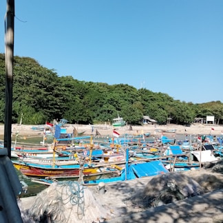 A vibrant display of colorful fishing gear laid out on a wooden dock by the water.