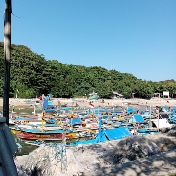 A vibrant display of colorful fishing gear laid out on a wooden dock by the water.