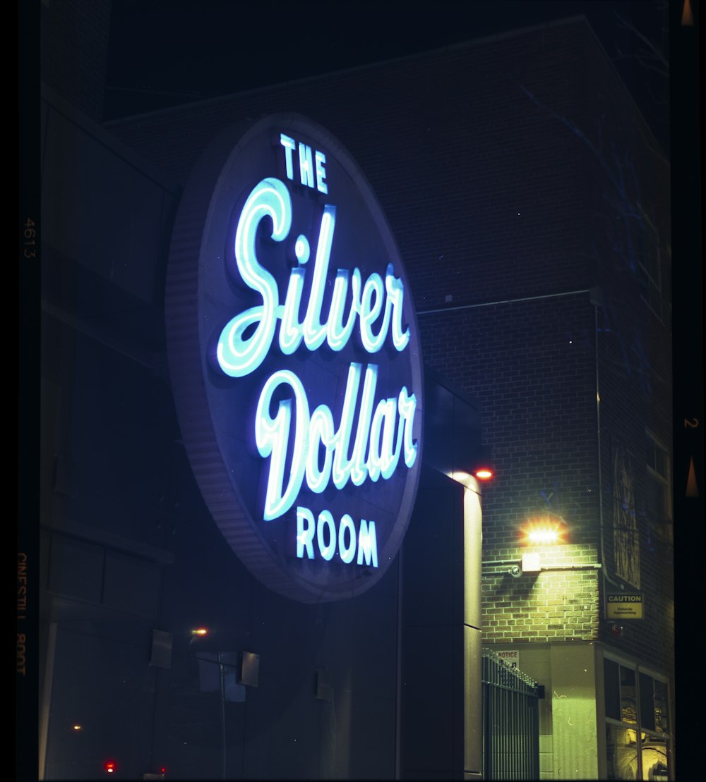 the silver dollar room sign lit up at night