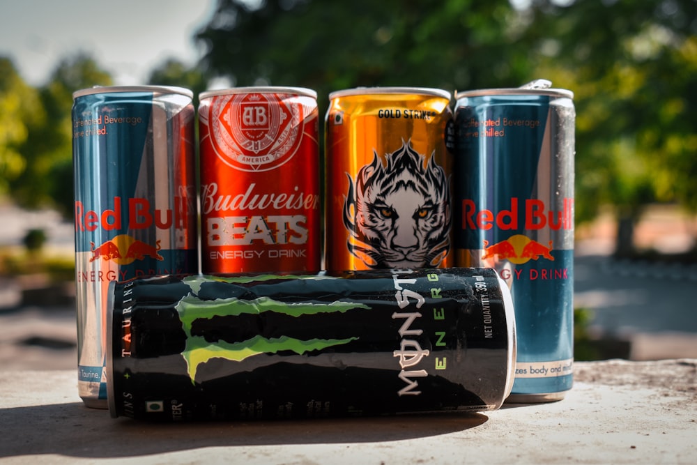 a group of four cans of soda sitting next to each other