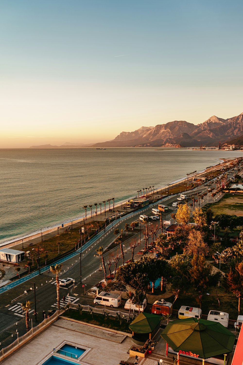 an aerial view of a parking lot next to the ocean