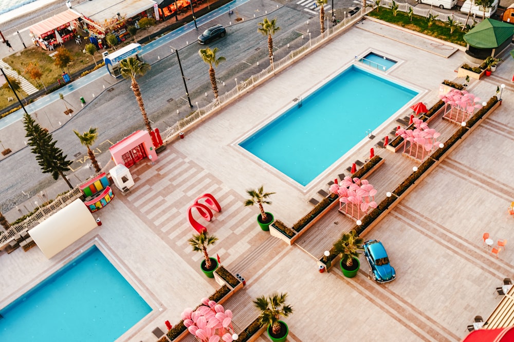 an aerial view of a pool and a parking lot