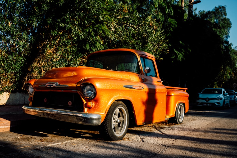 an orange truck parked on the side of the road