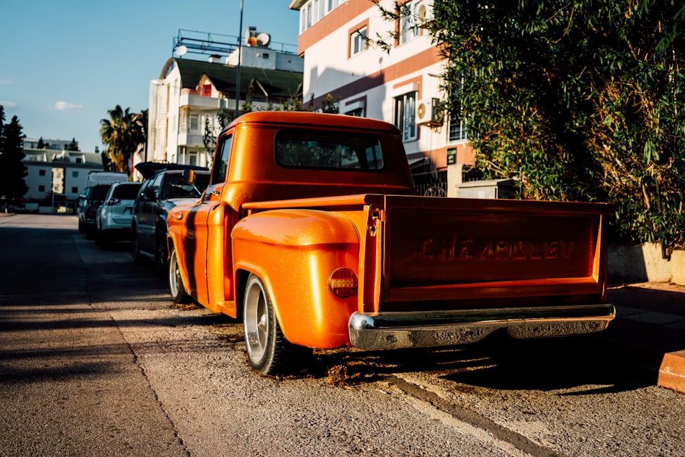 an orange truck parked on the side of the road