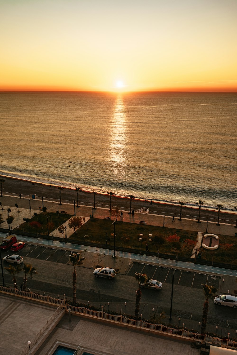 the sun is setting over the ocean and the beach