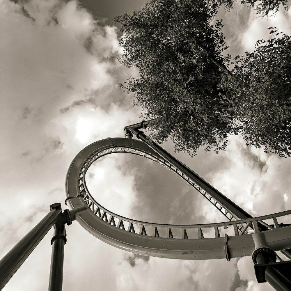 a black and white photo of a roller coaster