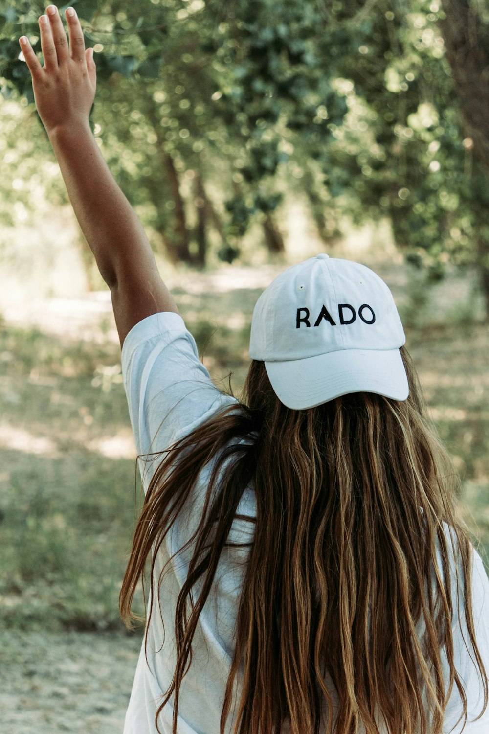 a woman with long hair wearing a white hat