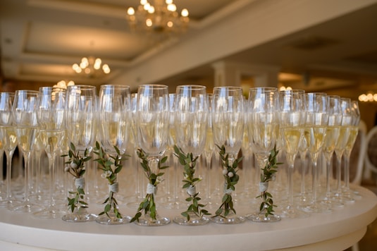 a table topped with lots of glasses filled with champagne