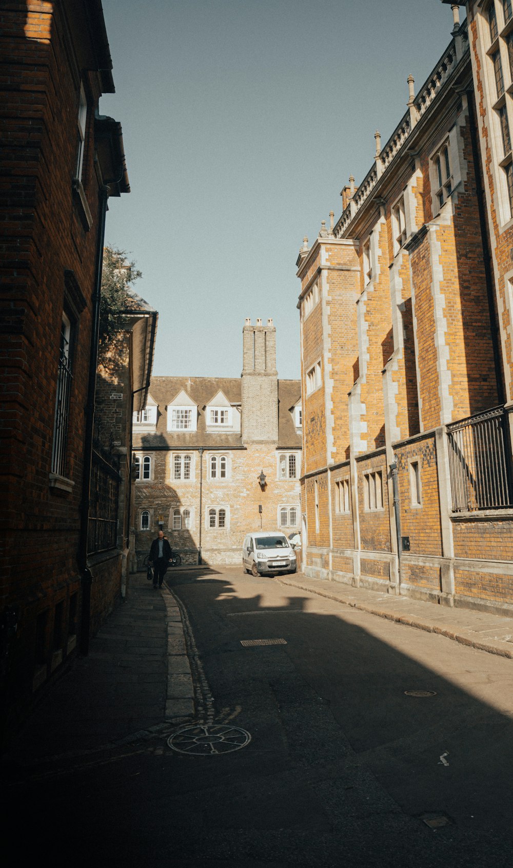 a car parked on the side of a road next to tall buildings