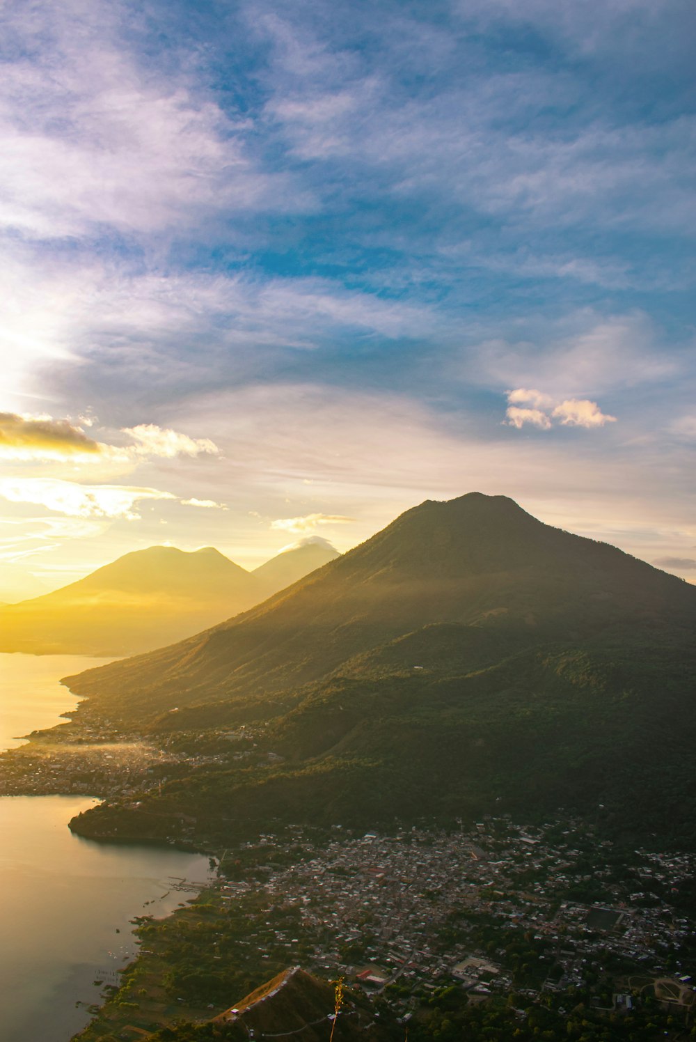 a view of a lake and a mountain at sunset