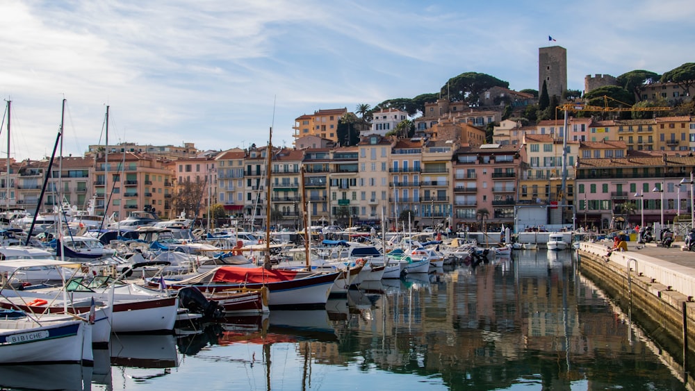 a harbor filled with lots of boats next to tall buildings