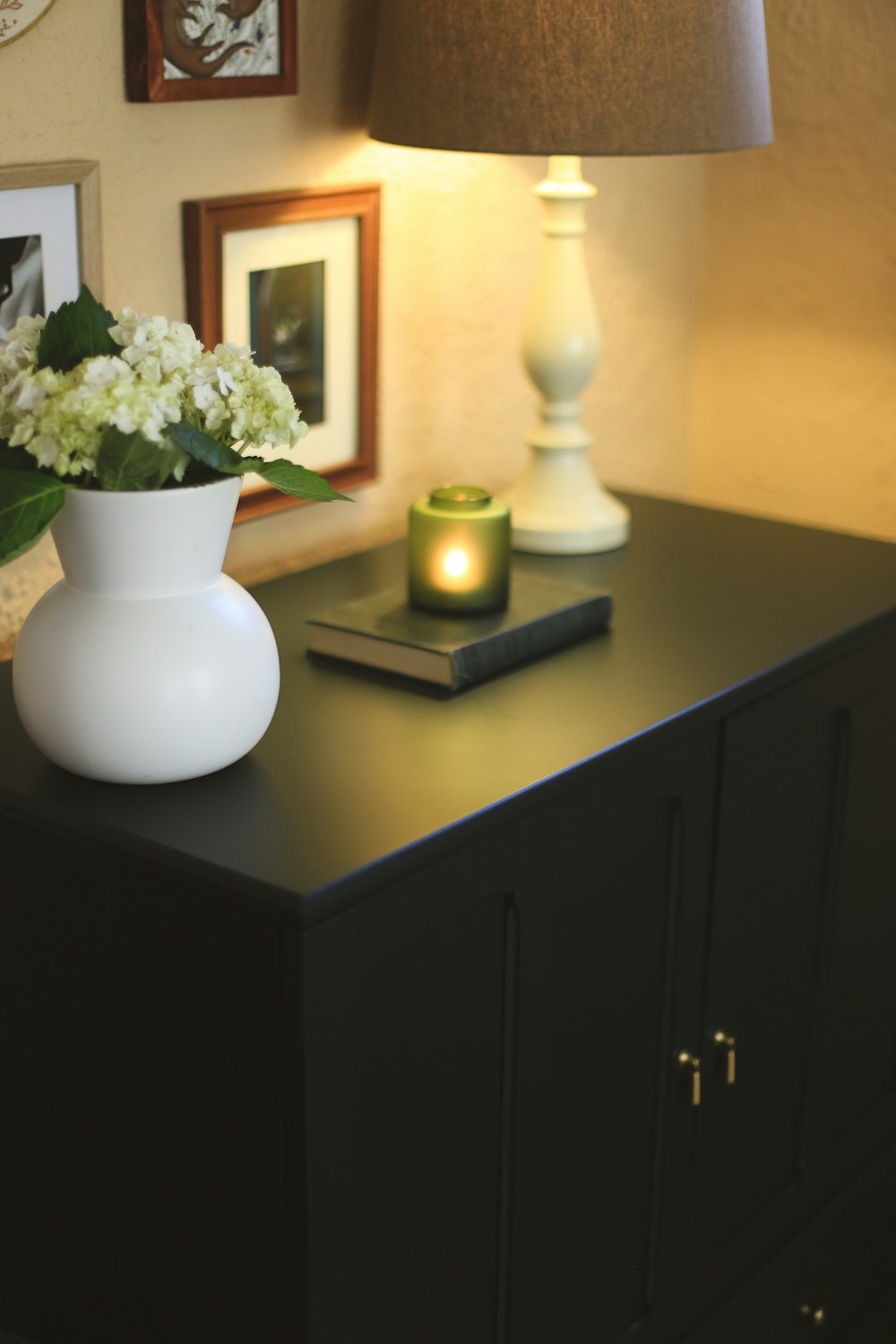 a table with a vase of flowers and a book on it