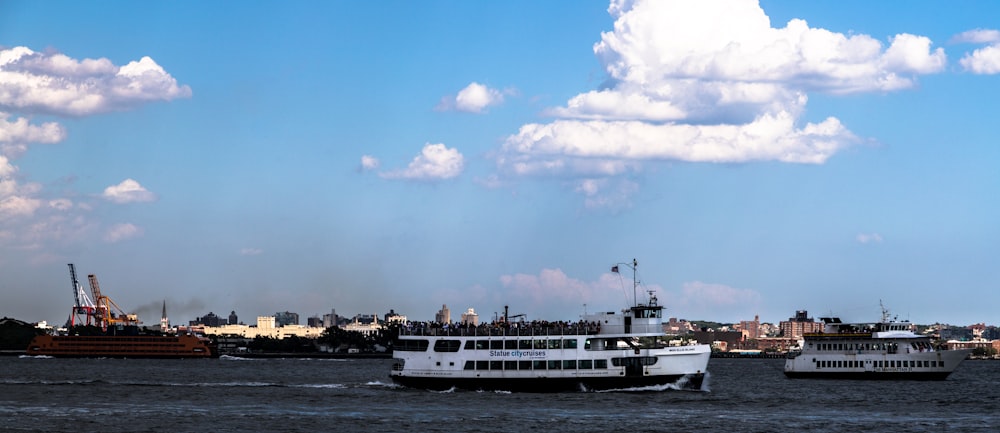 a large white boat traveling across a body of water