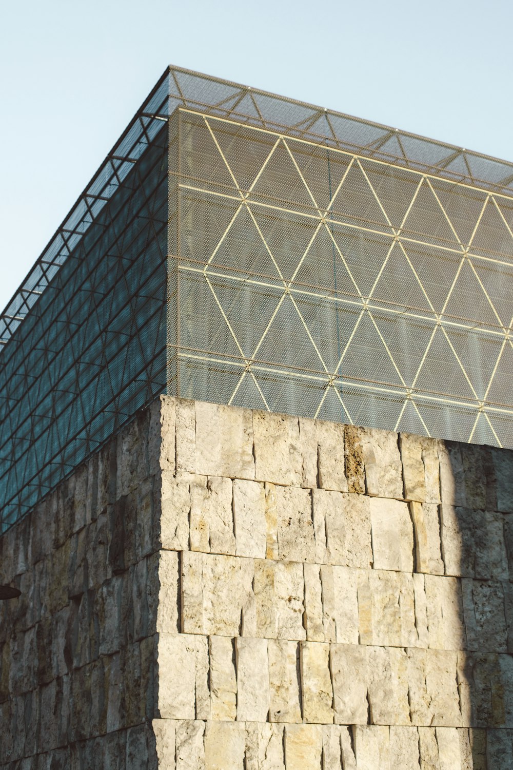 a large stone building with a glass window on top of it