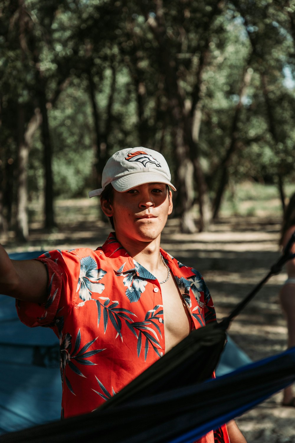 a man in a red shirt and a white hat