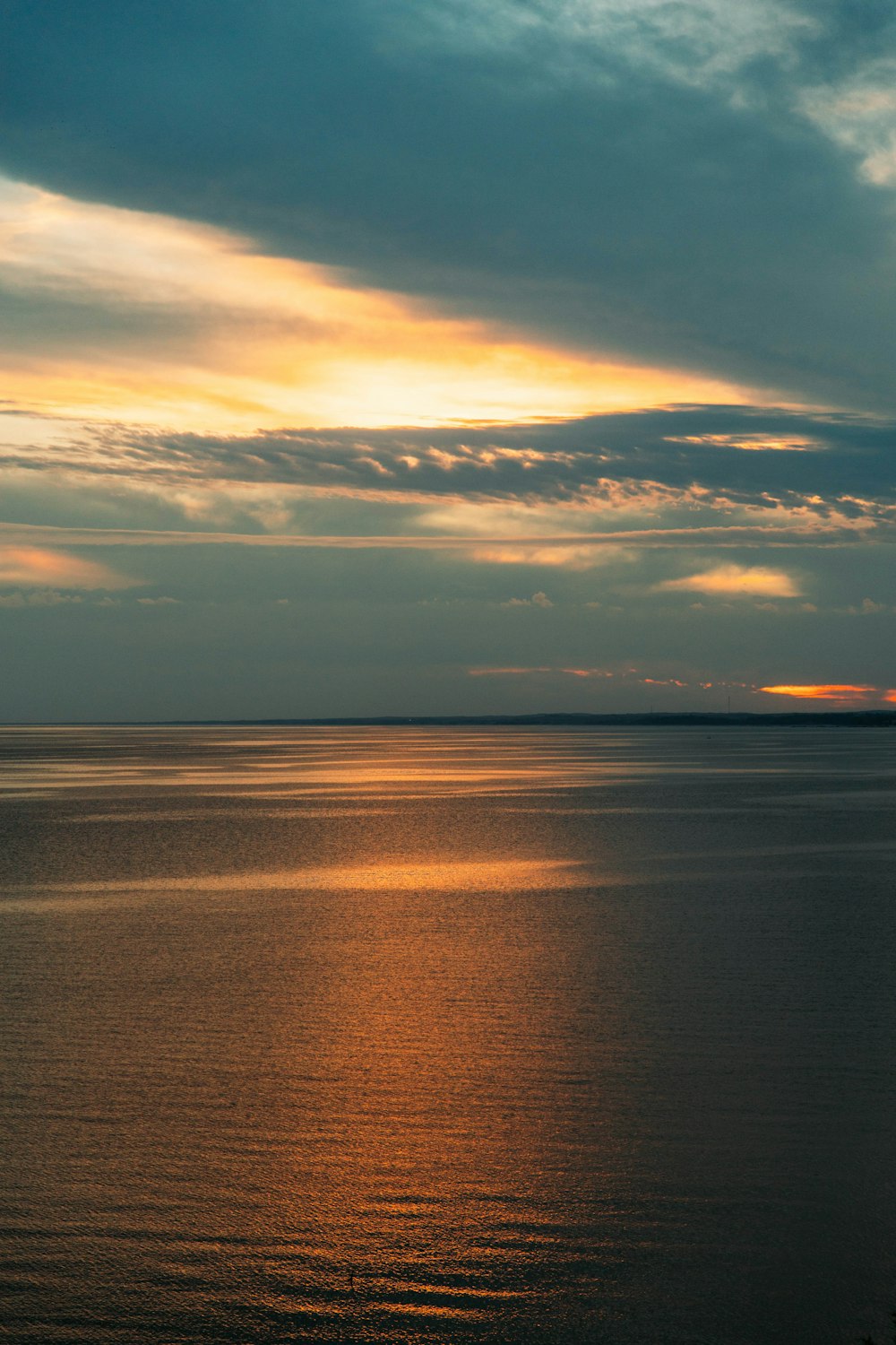 a large body of water under a cloudy sky