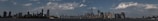 A panoramic view of a city skyline with financial district buildings.