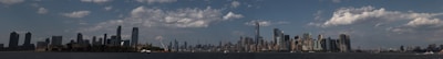 A panoramic view of a city skyline with financial district buildings.