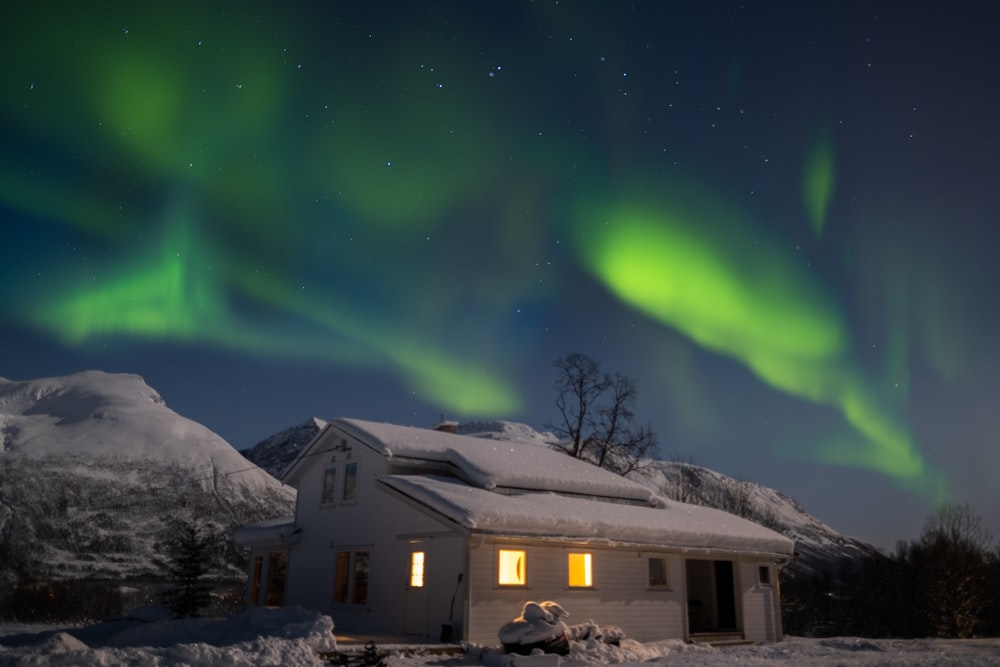 a house with a lot of green lights in the sky