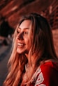 a woman with long blonde hair smiling at the camera