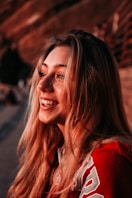 a woman with long blonde hair smiling at the camera