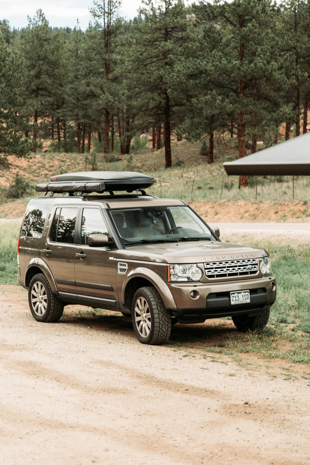 a land rover is parked on a dirt road